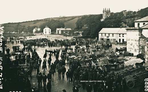 Fair day at Bantry, County Cork, about 1900: the square crowded with people, carts and cattle, the town and hills behind.