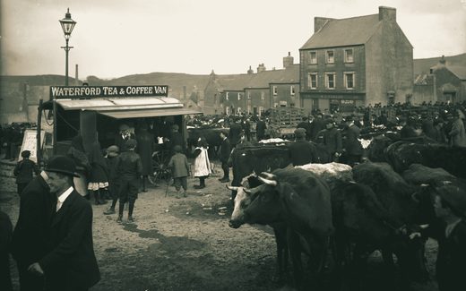 A tea and coffee van at a cattle fair about 1900, with families, children and neighbours gathered around it.